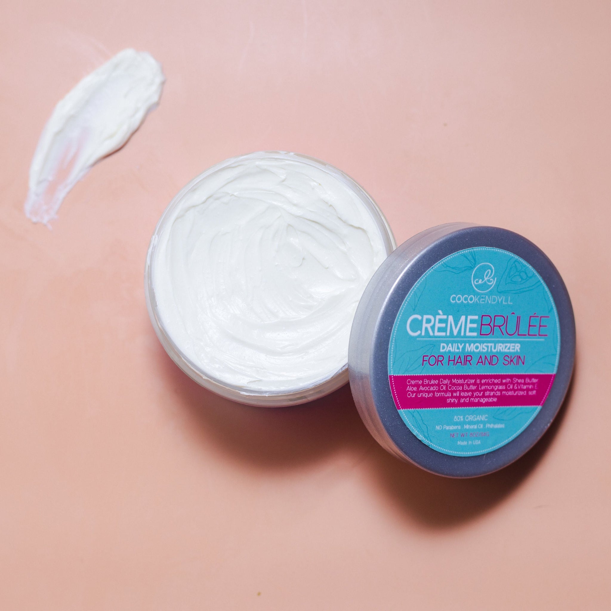 Open jar of Coco Kendyll Crème Brûlée Hair & Skin Butter- creamy whipped moisturizer for hair, scalp, and skin hydration.